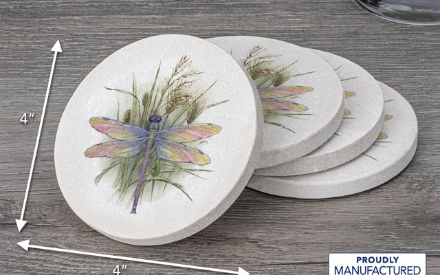Dragonfly patterned coasters fanned out on a grey wood tstable